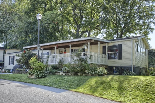 a home with a lawn and trees in the background