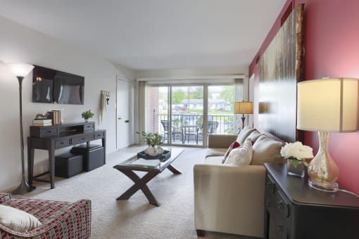Harrisburg Apartment | Twin Lakes Apartments | a living room with a sofa coffee table and a television in front of a sliding glass door