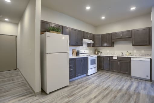 Mount Joy Senior Housing | a kitchen with dark cabinets and white appliances