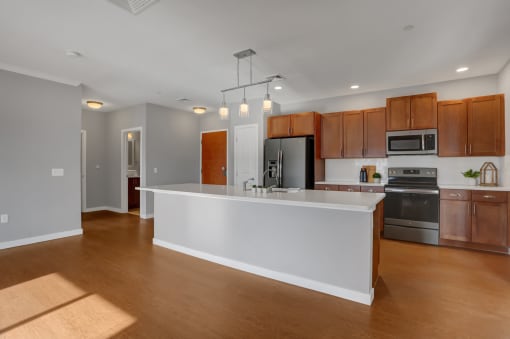 a kitchen with a large center island with a white countertop | Centerpointe Apartments in Camp Hill