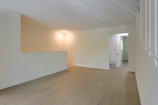 A room with wooden floors and white walls.