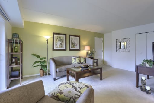 Apartments in Harrisburg | Twin Lakes Apartments | a living room with green walls and white carpet