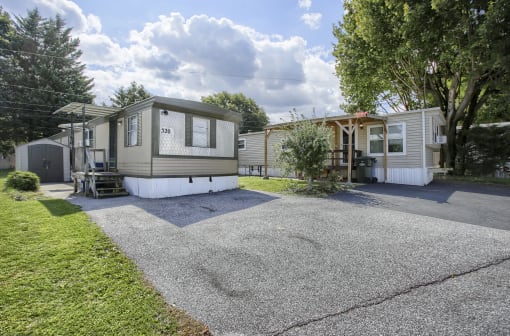 an rv is parked in the driveway of a mobile home park