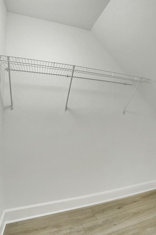 A metal rack is mounted on a white wall.