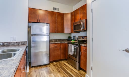a kitchen with stainless steel appliances and wooden cabinets
