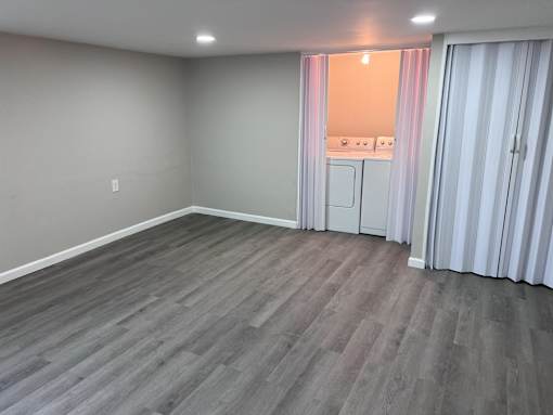 A room with a grey floor and white walls.