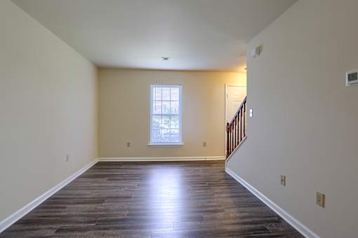 A room with wooden floors and a window.