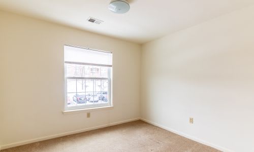 A room with a window and a ceiling fan.