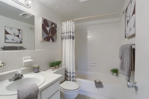 Apartments in Harrisburg | Twin Lakes Apartments | a bathroom with a white sink and toilet next to a white bathtub