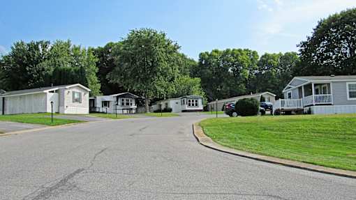 A street view of a residential area with houses on both sides.