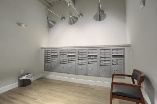 Mount Joy Senior Housing | a row of gray metal cabinets and a chair in a room with a hardwood floor