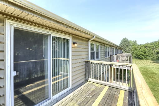 the view from the deck of a manufactured home with sliding glass doors