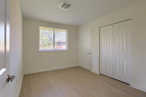 A room with a window and a door.