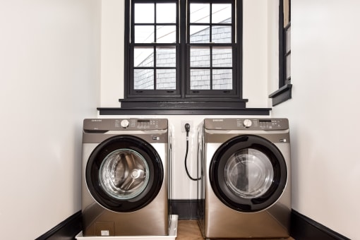 a washer and dryer in a laundry room with a window
