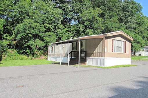 A mobile home with a porch and a covered entrance.