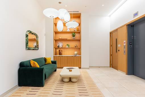 A living room with a green couch and a coffee table.