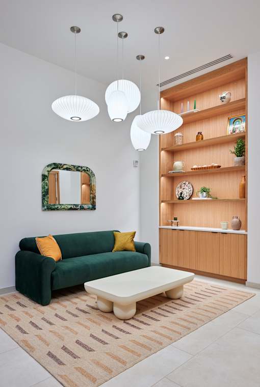a living room with a green couch and a coffee table