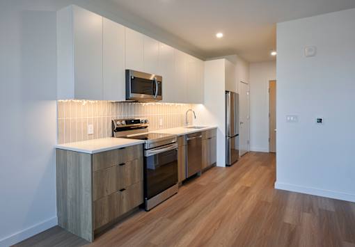 a kitchen with stainless steel appliances and white cabinets