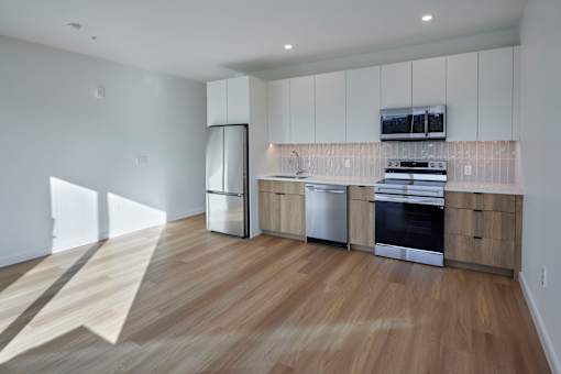 a kitchen with white cabinets and stainless steel appliances