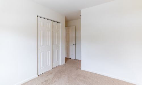 A white door is in a room with white walls.