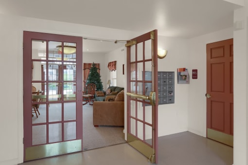 a living room with open doors and a couch