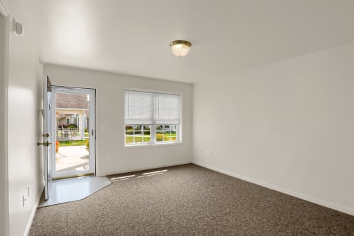 the living room of a house with a door to a patio