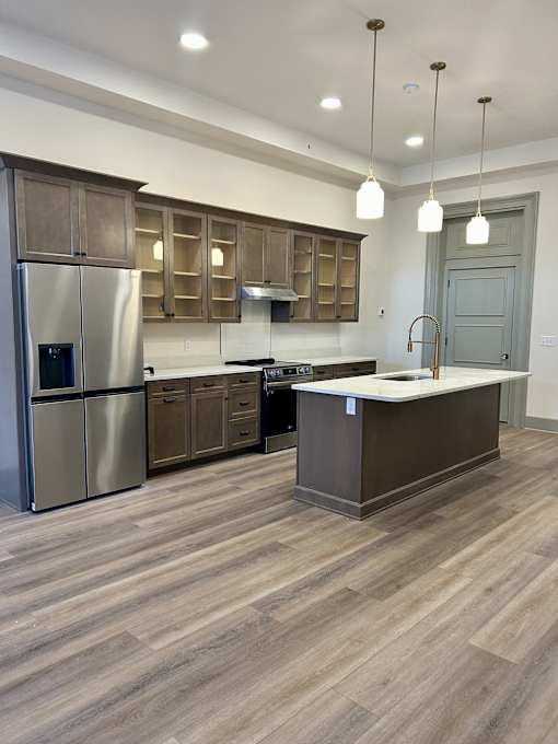 a kitchen with stainless steel appliances and wooden cabinets