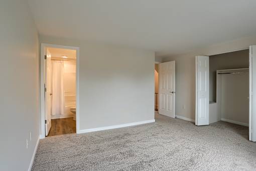 A room with carpeted floor and white walls.