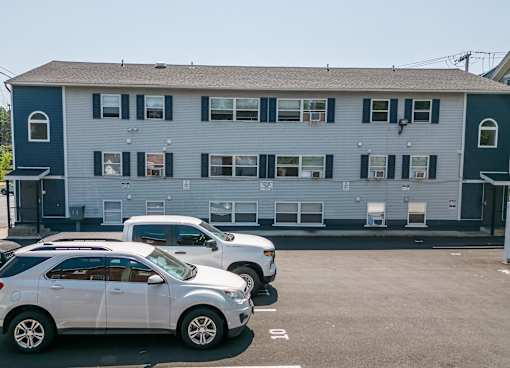 a blue building with cars parked in front of it
