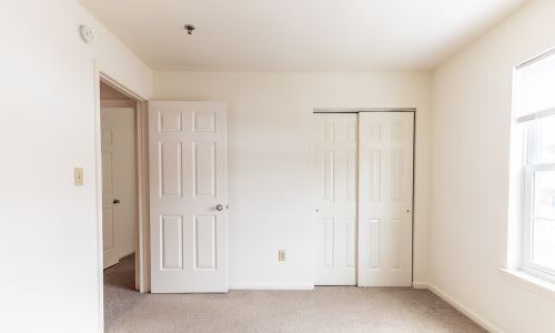 A room with two doors and a window.