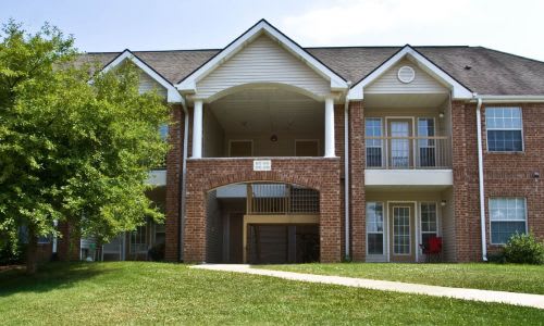 A large brick building with a covered walkway in front.