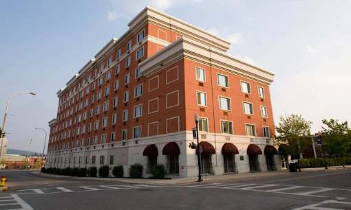 A large red brick building with arched windows and a white trim.