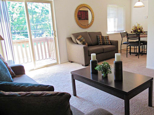 A living room with a couch, chairs, and a coffee table.
