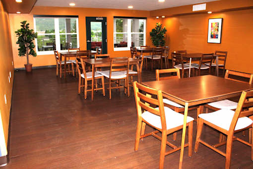 A restaurant with wooden tables and chairs.