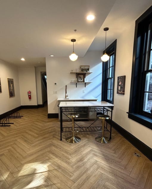 a dining area with a table and chairs in a room with a large window