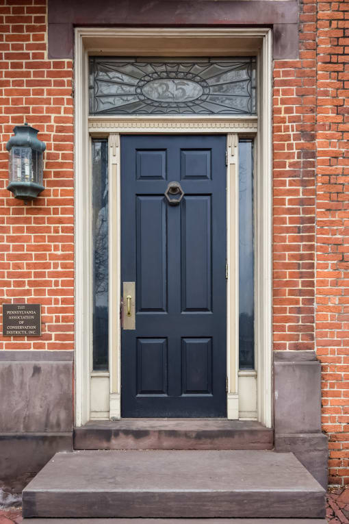 a blue door on a brick building