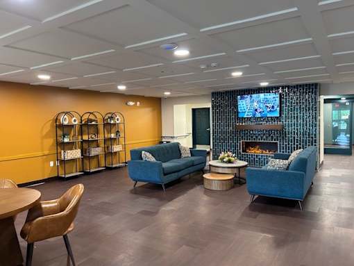A modern living room with a fireplace and a television.