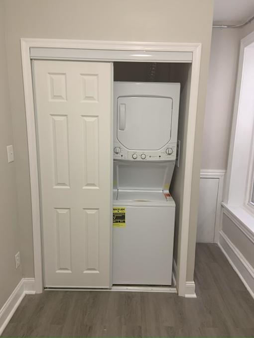 A white door with a small fridge in it.