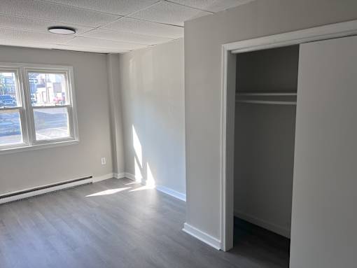 Empty room with a window and a door.