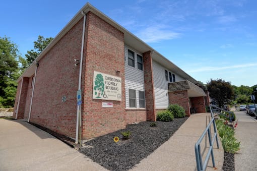 a brick building with a white sign on it