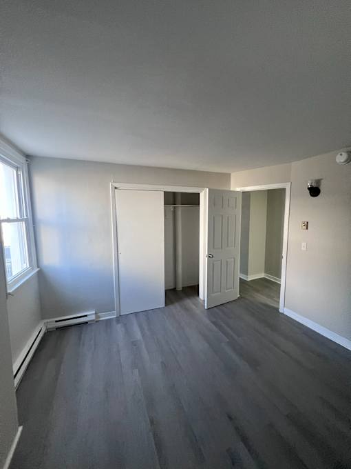 A room with grey flooring and white walls.