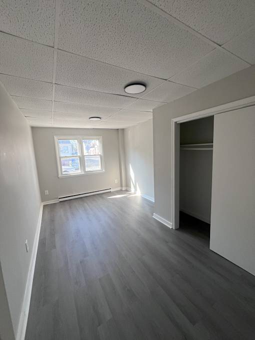 A room with a window and a door.