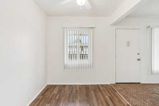 A room with a window and a door.