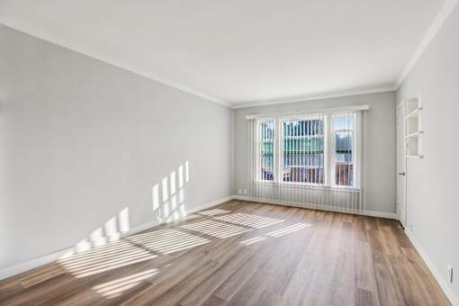 A room with wooden floors and white walls.