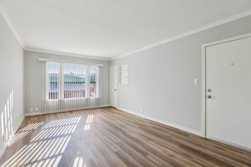 A room with wooden floors and white walls.