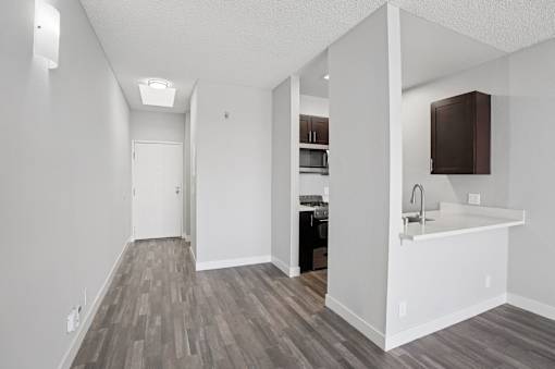A kitchen with a white counter and a sink.