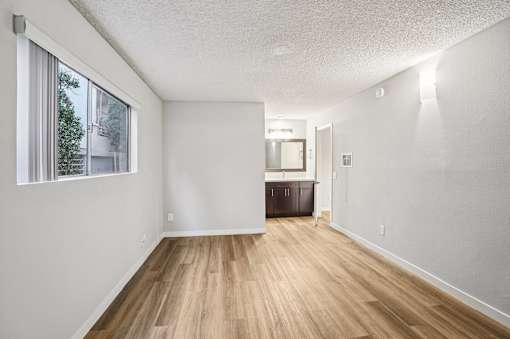 A room with wooden floors and white walls.