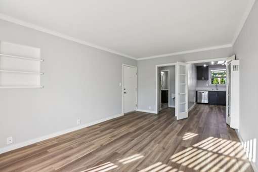 A room with wooden floors and white walls.