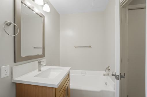 A white sink is on a countertop in a bathroom.