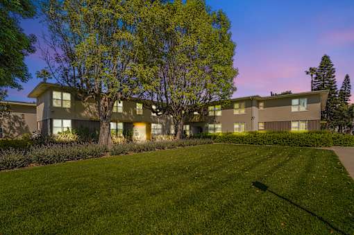 A building with a green lawn in front of it.